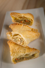 Crispy Chicken curry pie pastry, homemade bakery on white dish, selective focus