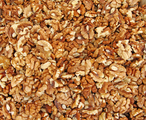 Full frame of peeled raw organic walnuts. Walnut background texture. Close up of nuts pattern. Walnuts wallpaper. Ripe and peeled walnut kernels.