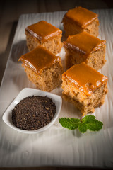 Milk tea cake with dried tea leaves, homemade bakery on white dish, selective focus
