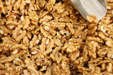 Full frame of peeled raw organic walnuts. Walnut background texture. Close up of nuts pattern. Walnuts wallpaper. Ripe and peeled walnut kernels.
