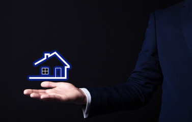 house icon in businessman hand
