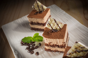 Coffee cake, Homemade bakery pastry with coffee beans on white dish, selective focus 