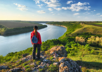 Fototapeta premium tourist on the rock. the girl looks at the picturesque canyon. spring Dniester