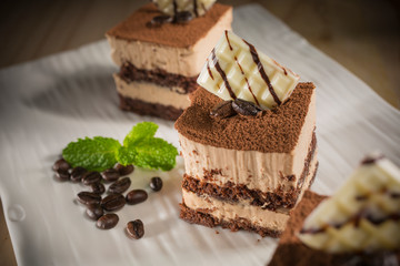 Coffee cake, Homemade bakery pastry with coffee beans on white dish, selective focus 