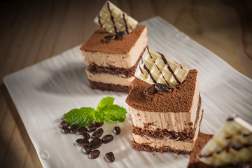 Coffee cake, Homemade bakery pastry with coffee beans on white dish, selective focus 