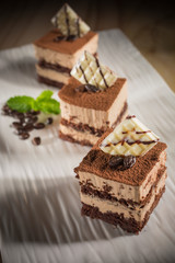 Coffee cake, Homemade bakery pastry with coffee beans on white dish, selective focus 