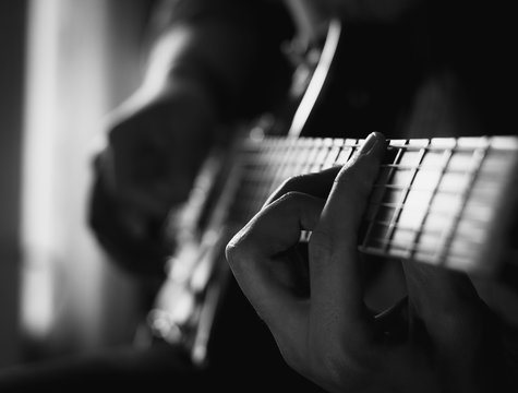 a young guy playing blues on an electric guitar. close-up.