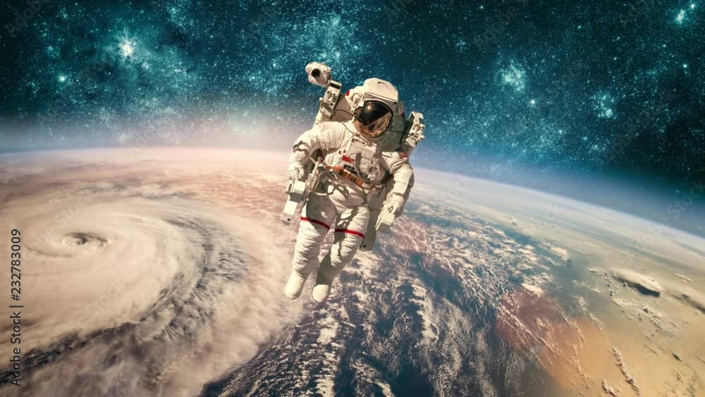 Wall mural astronaut in outer space against the backdrop of the planet earth. typhoon over planet earth. elemen