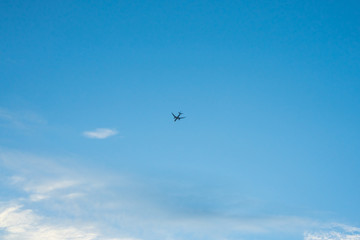 Naklejka na ściany i meble Airplane Flying in the Blue Sky