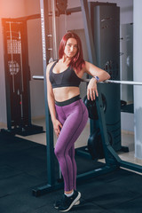 Beautiful athletic young woman making exercise at the gym. Young woman with muscular body.