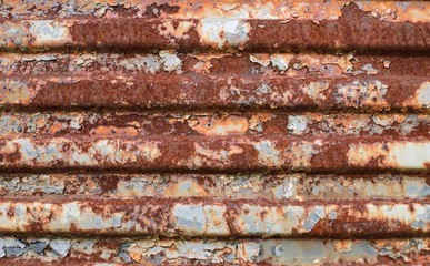 metal rusty wall with vertical ribs. Texture of fluted rusty metal plate