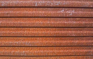 metal rusty wall with vertical ribs. Texture of fluted rusty metal plate