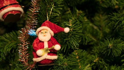 Santa doll hanging on a Christmas tree