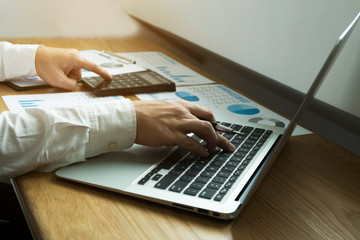  Businessman using laptop to the situation on the market value , Business concept.