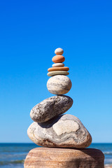 Gray and red zen stones on the background of the sea. Concept of harmony, balance and meditation.