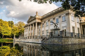 Fototapeta na wymiar Royal Palace from the Side on the Water in Lazienki Park, Warsaw, Palace on the water in the Royal Baths in Warsaw, Poland