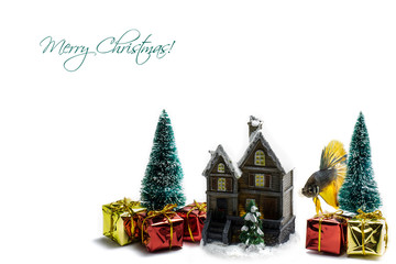 Two pines with Christmas presents and gifts, small house isolated on white background. Merry Christmas text on the top left. Siamese fighting fish next to the house.