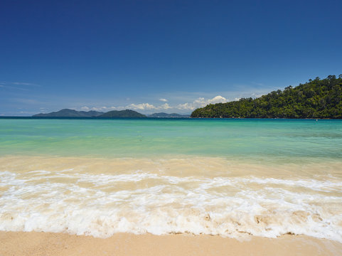 Beatiful wave of turquose water cover sand