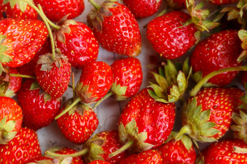 Strawberry just collected from the garden. background of strawberries. Fresh Strawberry Background. Strawberries background. Fresh ripe strawberry just picked from the farm. Close up.