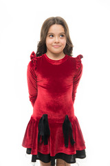 Fashion concept. Kid adorable smiling posing in red velvet dress. Kids fashion. Girl cute child...