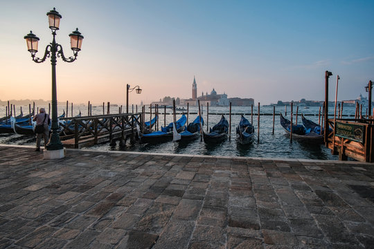 Venice, Italy, September 17, 2018 - Tourist take pictures sunrise on the waterfront next to the Doge Palace