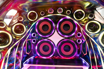 colorful lights of stereo and speakers in car in the night