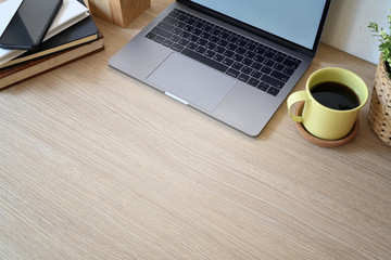 Office wooden desk with laptop, office supplies and copy space.