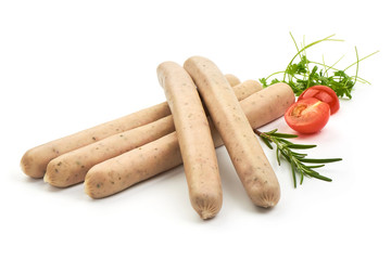 Raw Nuremberg Sausages with herbs and tomatoes, isolated on a white background. Close-up.