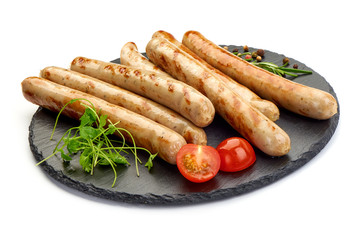 Grilled Nuremberg Sausages on a slate shale plate, isolated on a white background. Close-up.