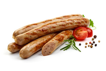 Grilled Nuremberg Sausages with herbs, pepper and tomatoes, isolated on a white background. Close-up.