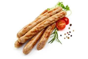 Fried Pork Chipolata Sausages with herbs, pepper and tomatoes, isolated on a white background. Close-up.