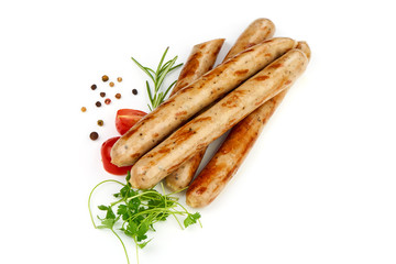 Fried Sausages For Beer with herbs, pepper and tomatoes, isolated on a white background. Close-up.