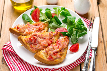Open sandwich tartine with tomato, ham and cheese