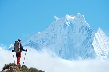 Hiker with backpacks in Himalayas mountain, Nepal. Active sport concept.