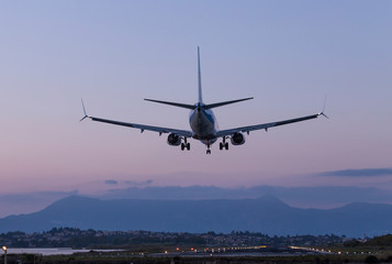 the plane lands in the evening to the runway of the airport Ioannis Kapodistrias of greek island...