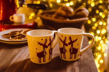 Christmas party, croissants with hot chocolate. Christmas tree with lights