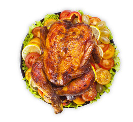 Whole fried chicken or Turkey with vegetables and lettuce on white isolated background. The view from the top.