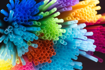 Colorful plastic drinking straws, close up as background