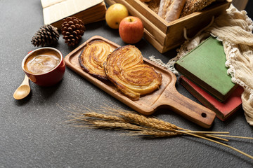 Fototapeta na wymiar coffee and bread on wood tray in warm tone.