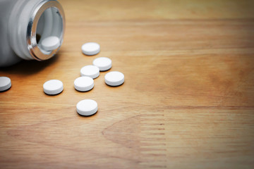 ound pills on wood table,medicine