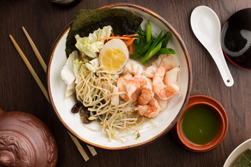 Asian ramen with shrimps and noodles in a restaurant