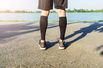 runner wear the compression sleeve and shoes for marathon