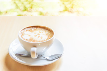hot cappuccino coffee with cute cream rabbit pattern on table