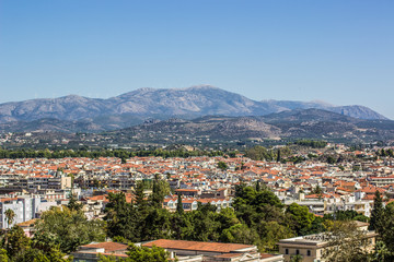 Fototapeta na wymiar south city panorama and many buildings with orange shingles roofs on background of mountain horizon landscape 