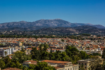Fototapeta na wymiar south city panorama and many buildings with orange shingles roofs on background of mountain horizon landscape 