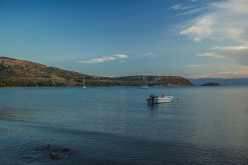 Fototapeta na wymiar yacht and boat cozy sea bay nature landscape view and calm water surface in twilight evening time