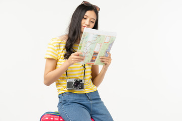 Beautiful young woman smiling and pulling pink color luggage isolated on white background.Woman going to summer vacation.Travel trip funny...