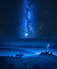 Milky way over the valley with small house in Italy