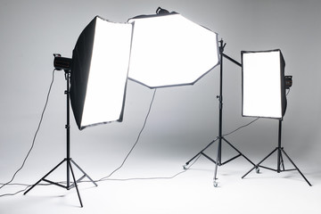 Empty photo studio with lighting equipment. Photo staff.