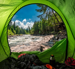 View form tent to cold river in Tatras in summer